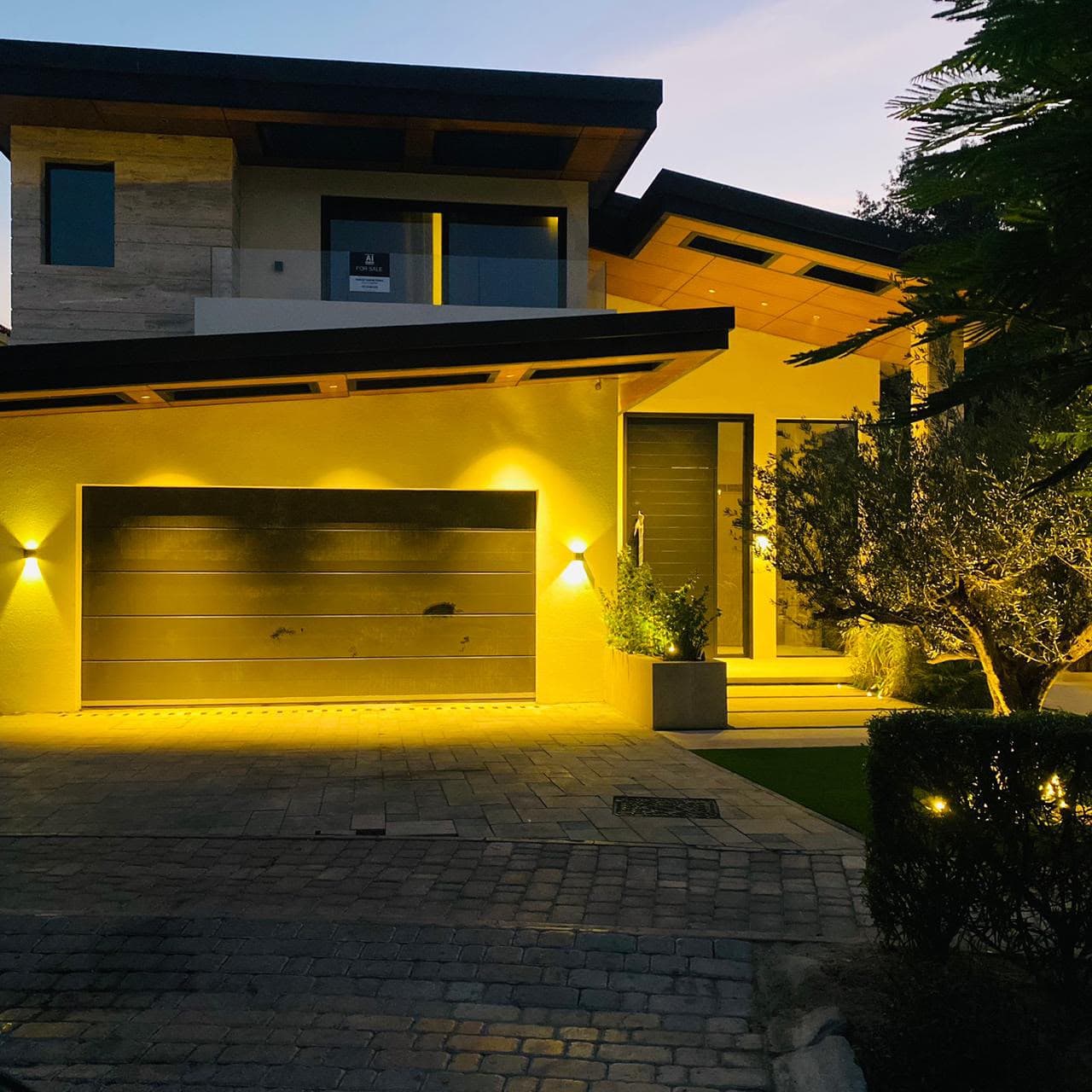 Villa garage and facade lit at night