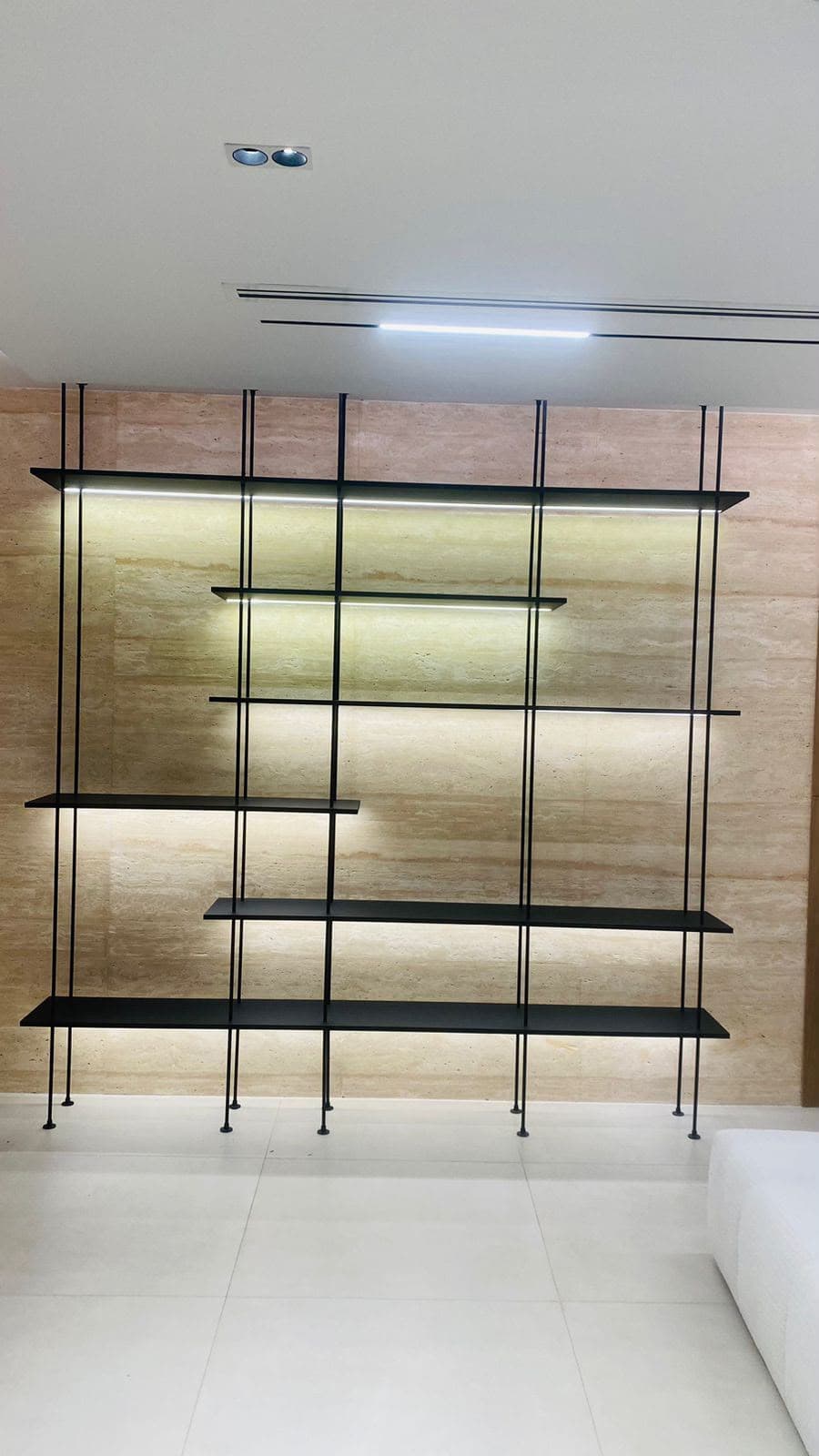 Custom-lit shelving fabricated in aluminium and glass