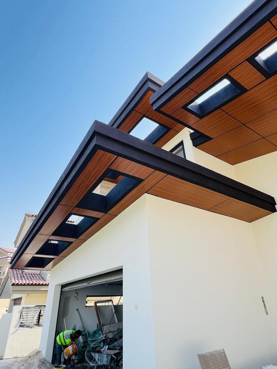 Timber-slat pergola over an outdoor dining area at night
