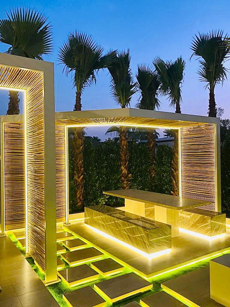 Villa pool and pergola with neighbouring villas in the background