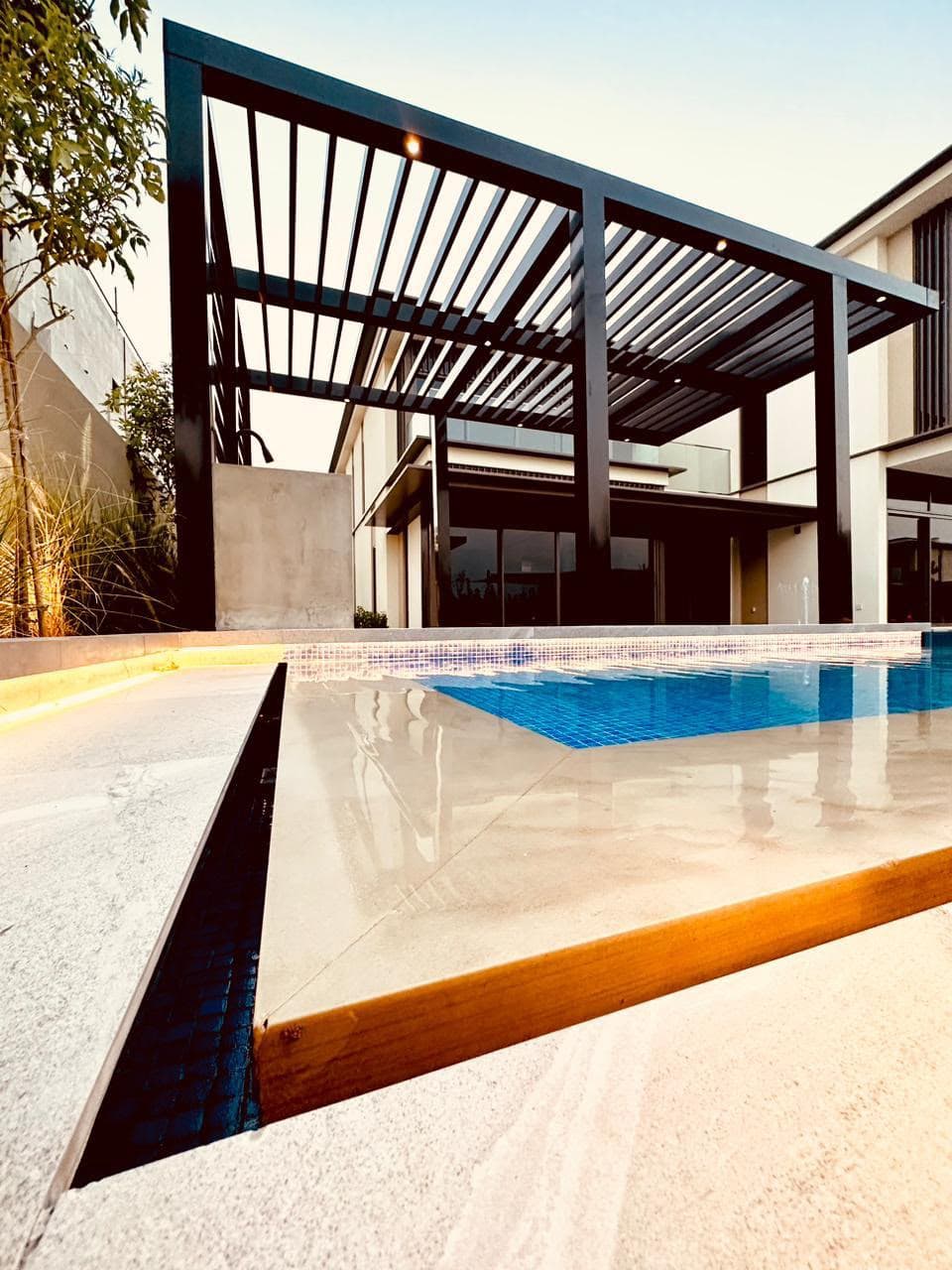 Pergola and pool at warm sunset