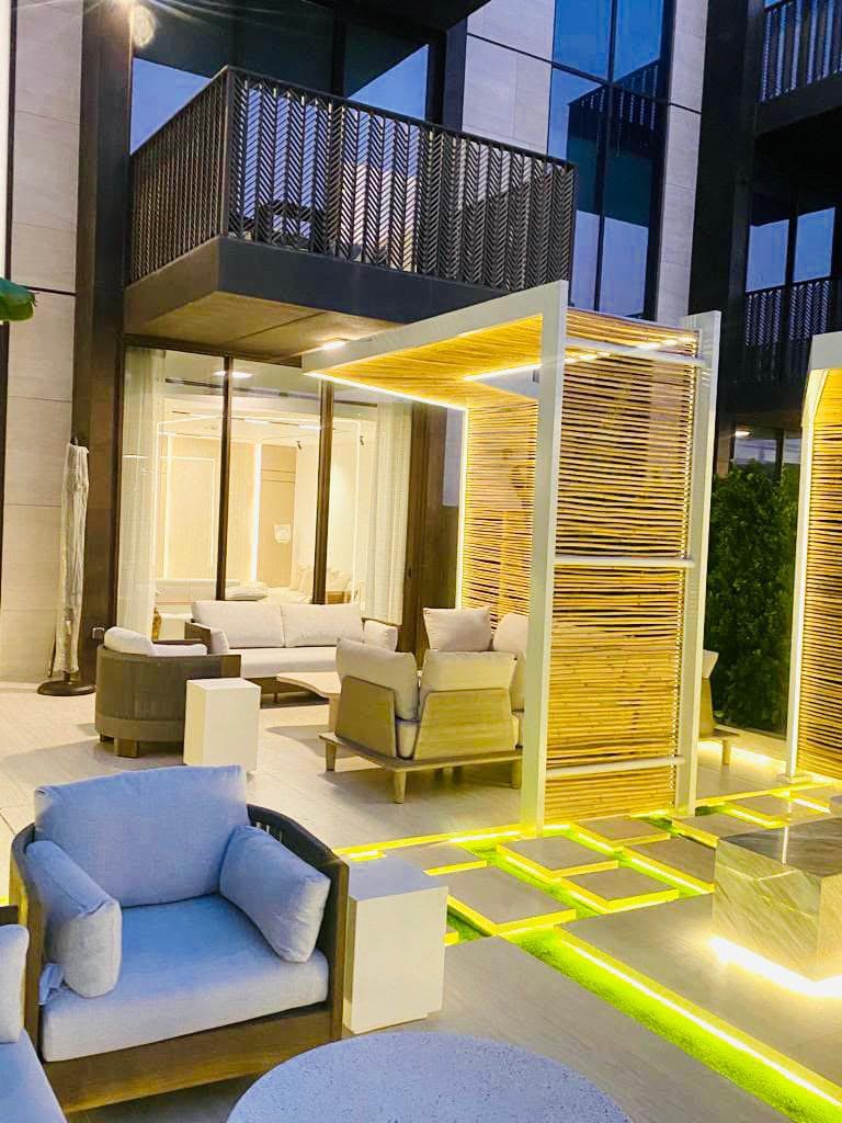 Rooftop lounge under a bamboo-slat pergola